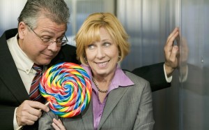 Man in office offers coworker a lollipop